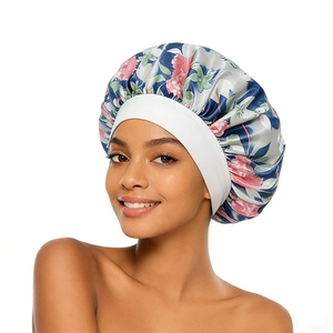 Floral satin sleep bonnet with wide elastic band worn by model for hair protection