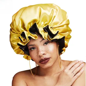 Detail of double-layer satin sleep bonnet in yellow and black with elastic band