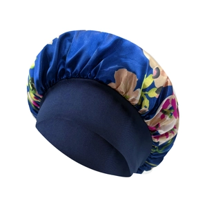 Detail of floral printed satin sleep bonnet with a navy blue wide elastic headband