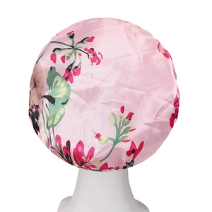Detail of pink satin floral hair bonnet with elastic wide band for hair protection
