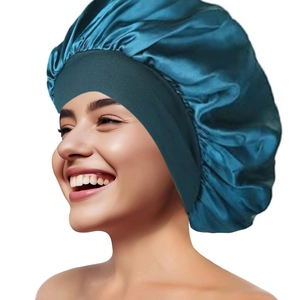 Detail of teal satin bonnet with wide elastic band showing smooth silk texture for hair care