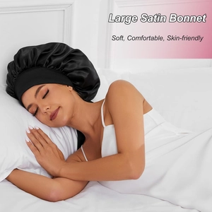 Close-up of a large black satin bonnet with elastic band for hair care during sleep