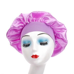 Detailed view of pink satin hair bonnet with wide elastic headband on mannequin head