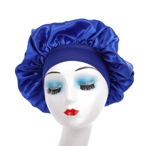 Detail of royal blue satin sleep bonnet with wide elastic band on mannequin head