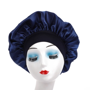 Detail of dark blue satin hair bonnet with black wide elastic band on a model