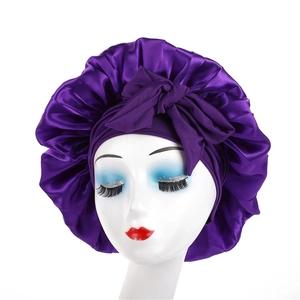 Elastic purple satin sleep bonnet with a decorative bow and soft silk-like texture