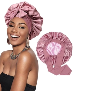 Satin bonnet sleep cap for hair care in dusty rose with wide decorative ribbon bow