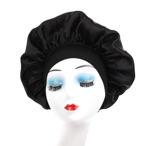 Black satin sleep cap with wide elastic band on model for hair protection and beauty care