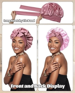Detail view of the long elastic straps and silky satin texture of the sleeping bonnet