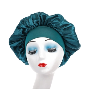 Detail of the elastic wide band and dark green satin silk fabric on the hair bonnet