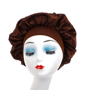 Detailed close-up of dark brown satin sleep cap with wide elastic band on a model head