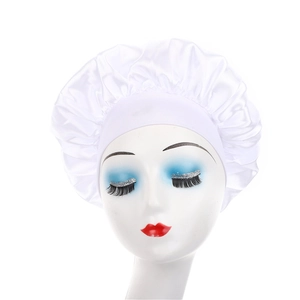 Detailed view of white silk satin bonnet on mannequin head for night hair care