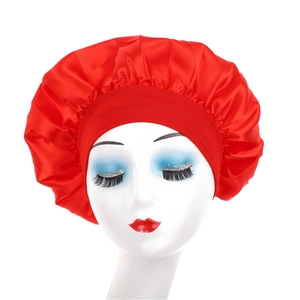 Detail of red satin sleep bonnet with wide elastic band on model head for hair care