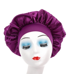 Detail of deep purple satin sleep bonnet with wide elastic band on mannequin head