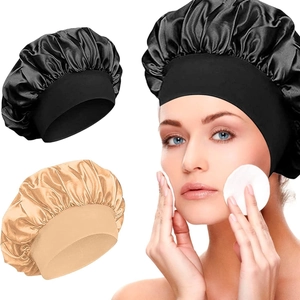 Silky satin sleep cap for hair care in black and champagne gold with wide elastic band