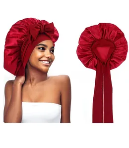 Detailed close-up of dark red satin bonnet sleep cap featuring a wide band and tie bow
