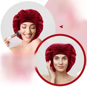 Macro detail of wine red satin sleep cap with large bow for skincare and makeup routines