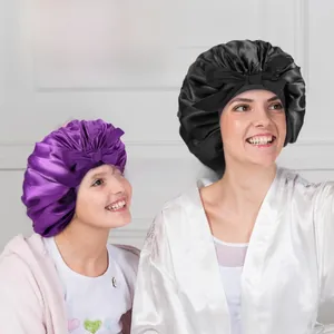 Detail showing smooth satin sleeping bonnets with bow decoration in black and purple colors