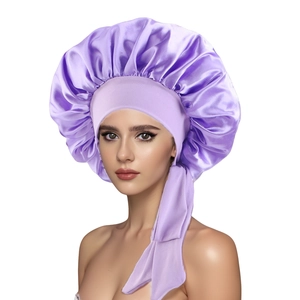 Detailed texture of the light purple satin sleep bonnet with adjustable ribbon ties