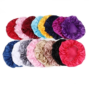 Flat lay display of 16 different colored satin sleep bonnets with elastic lace edges