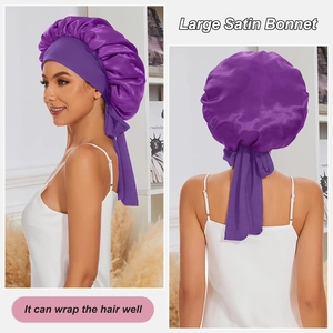 Large purple satin bonnet with wide elastic band and long ribbon straps for hair care
