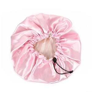 Pink satin hair bonnet with adjustable drawcord and silky finish for hair protection