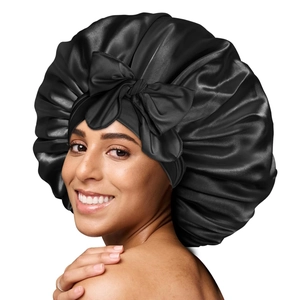 Black satin sleep bonnet with oversized bow and elastic band for long hair protection