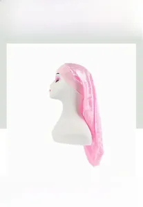 Detail of pink satin sleep bonnet showing smooth texture and elastic wide band for hair care