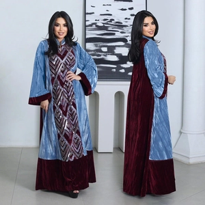 Close-up of velvet patchwork abaya with intricate sequin embroidery and pleated fabric