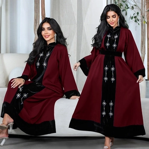 Close-up of burgundy robe featuring velvet patchwork and sparkling sequin star details