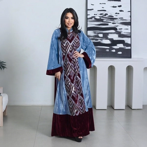 Detail of blue textured abaya with silver sequin embroidery and red velvet trim accents