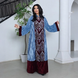 Detail of velvet patchwork abaya with sky blue texture and red sequin diamond patterns