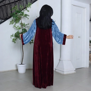 Detail of burgundy velvet robe with light blue pleated flare sleeves and rhinestone accents