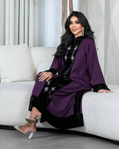 Detail of velvet abaya featuring blue and white star pattern rhinestone embellishments