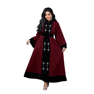 Detailed embroidery on the black velvet panel of this elegant red velvet patchwork abaya