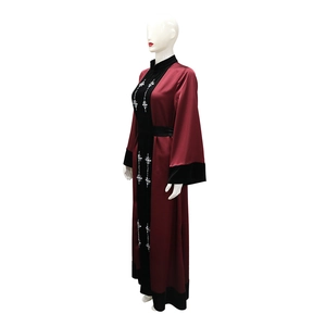 Macro shot of rhinestone star patterns on wine red velvet and satin spliced abaya