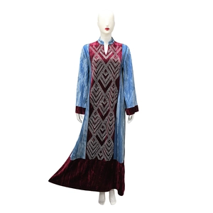 Detail of velvet patchwork kaftan with rhinestone geometric patterns and long sleeves