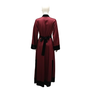 Rear view of luxury burgundy satin robe featuring black velvet patchwork and bow belt