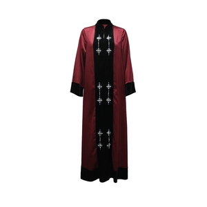 Detail of burgundy satin robe with black velvet panel and shimmering rhinestone accents