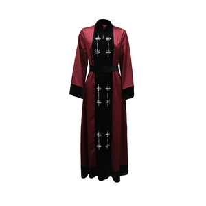 Detailed close-up of rhinestone floral patterns on velvet patchwork and burgundy satin fabric