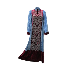 Detail of velvet patchwork kaftan dress featuring sparkling rhinestone geometric patterns