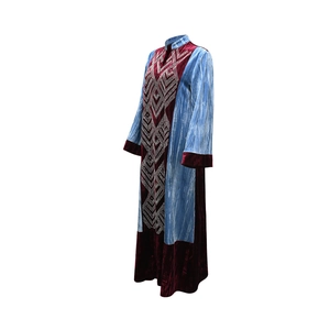 Detail of color-block velvet kaftan dress with intricate rhinestone geometric patterns