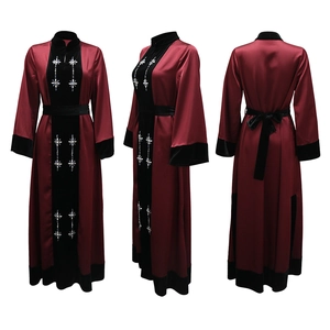 Detail of burgundy satin dress with velvet patchwork and sparkling rhinestone cross patterns