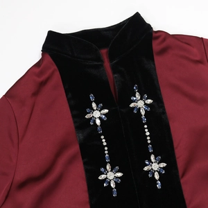 Close-up of velvet and satin patchwork with floral rhinestone embroidery on a robe