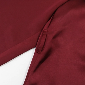 Macro shot of burgundy velvet satin robe stitching and durable belt loop detail
