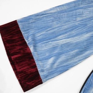 Detail of velvet robe sleeve showing sky blue embossed fabric and burgundy cuffs