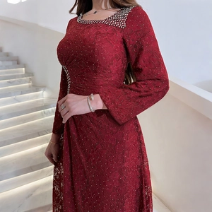 Detail of burgundy lace evening gown featuring intricate silver rhinestone waist embellishments