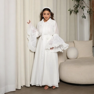 Close-up of white Abaya dress featuring elegant layered lace flare sleeves and waist tie