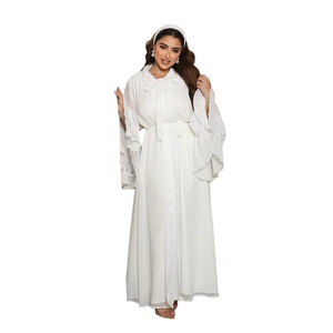 Detail of elegant flared sleeves with lace patchwork and pleats on a white abaya dress