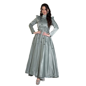 Close-up of intricate floral embroidery and 3D applique on sage green satin dress